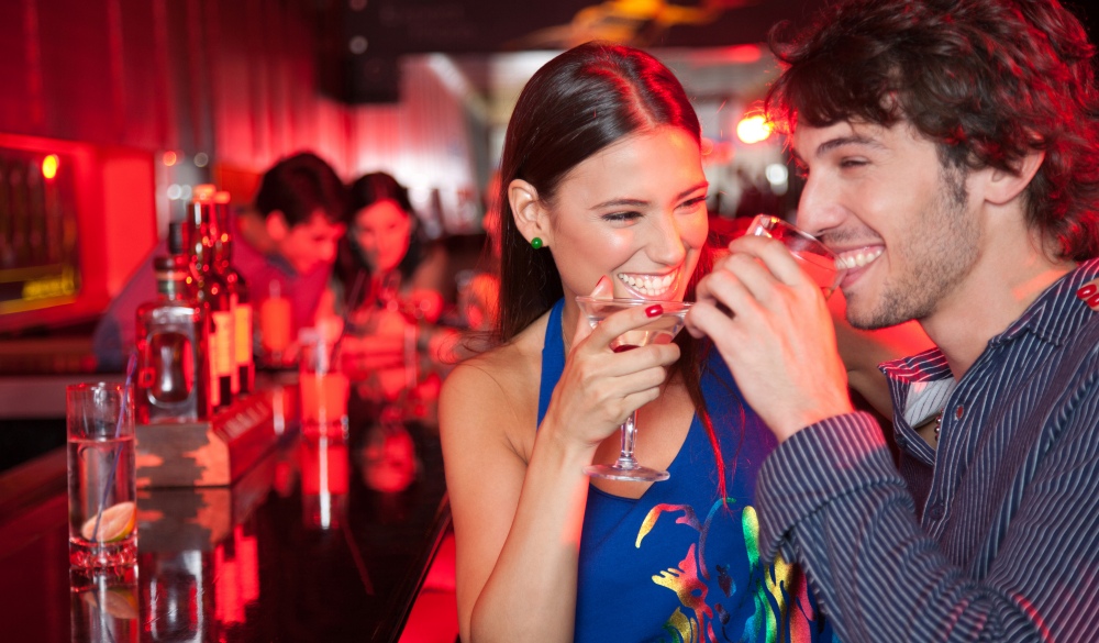 Smiling couple in nightclub with beverage, Quezon City