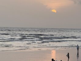 Sunset at Alibaug Beach, Maharashtra with people on the shore