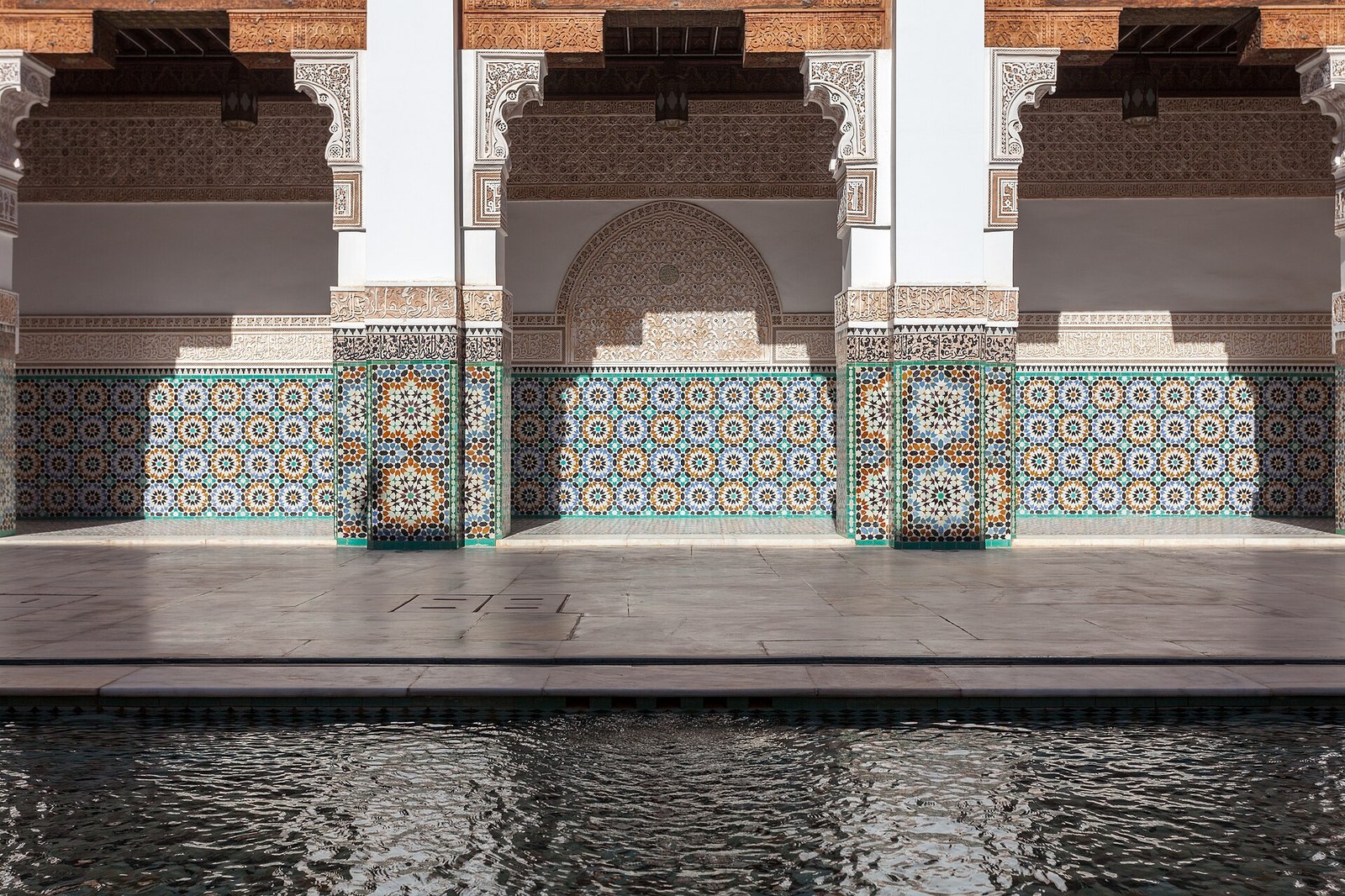 Ben Youssef Madrasa courtyard in Marrakesh with zellige tilework and reflecting pool