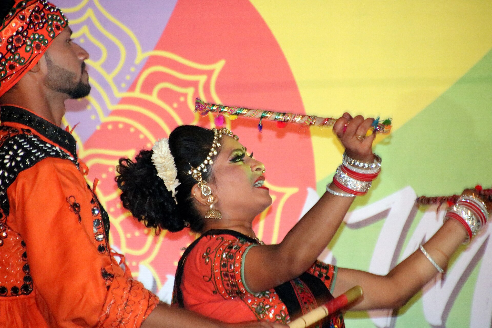 Dancers with painted sticks performing dandiya raas during Navratri