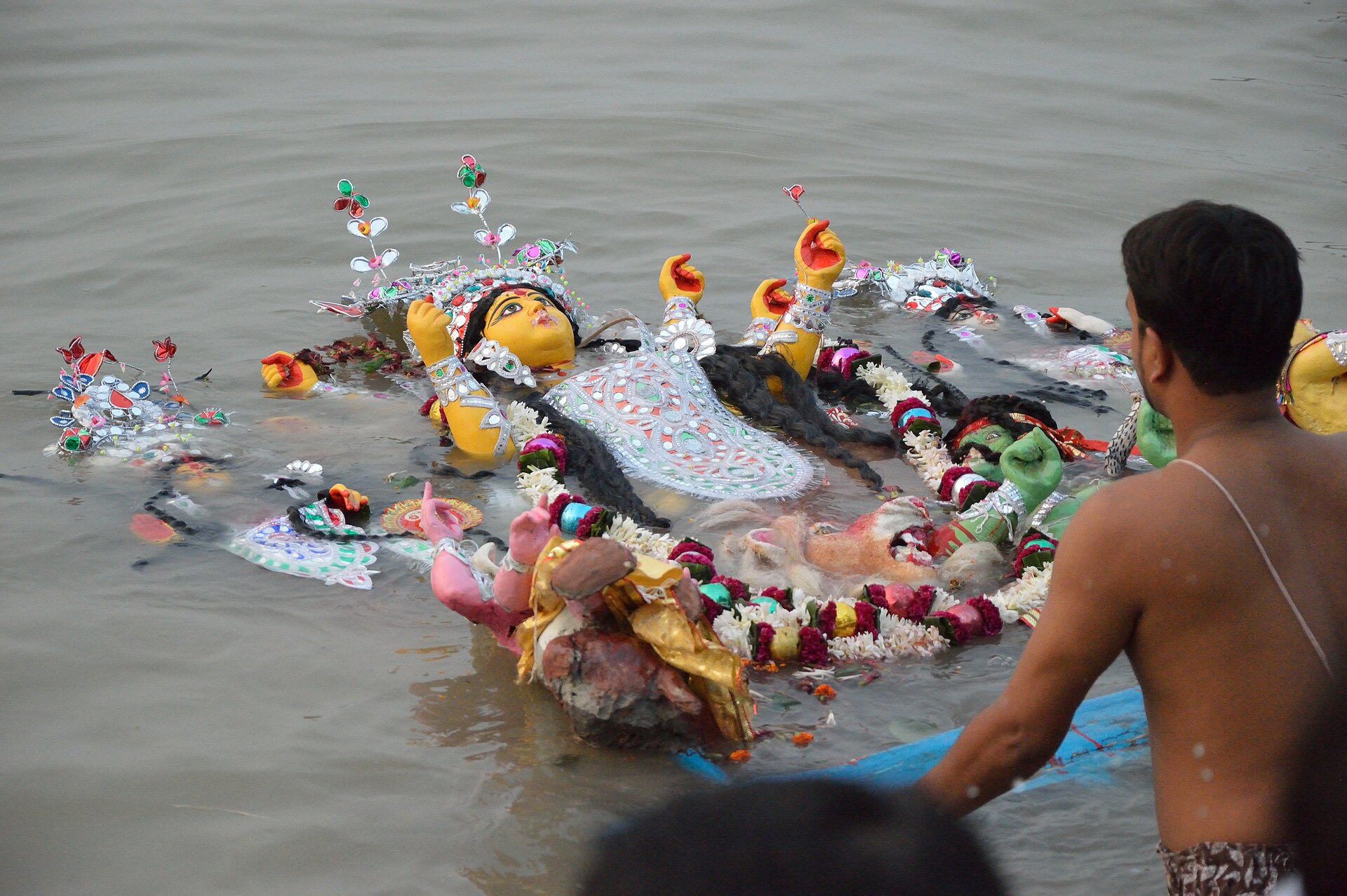 Durga idol being carried into the Hooghly river for immersion at Bagbazar ghat
