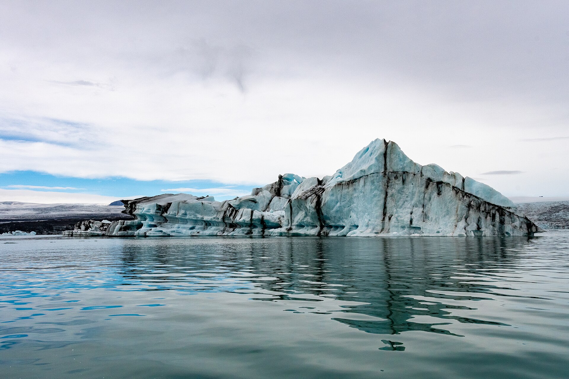 Striped iceberg floating in Jokulsarlon glacier lagoon