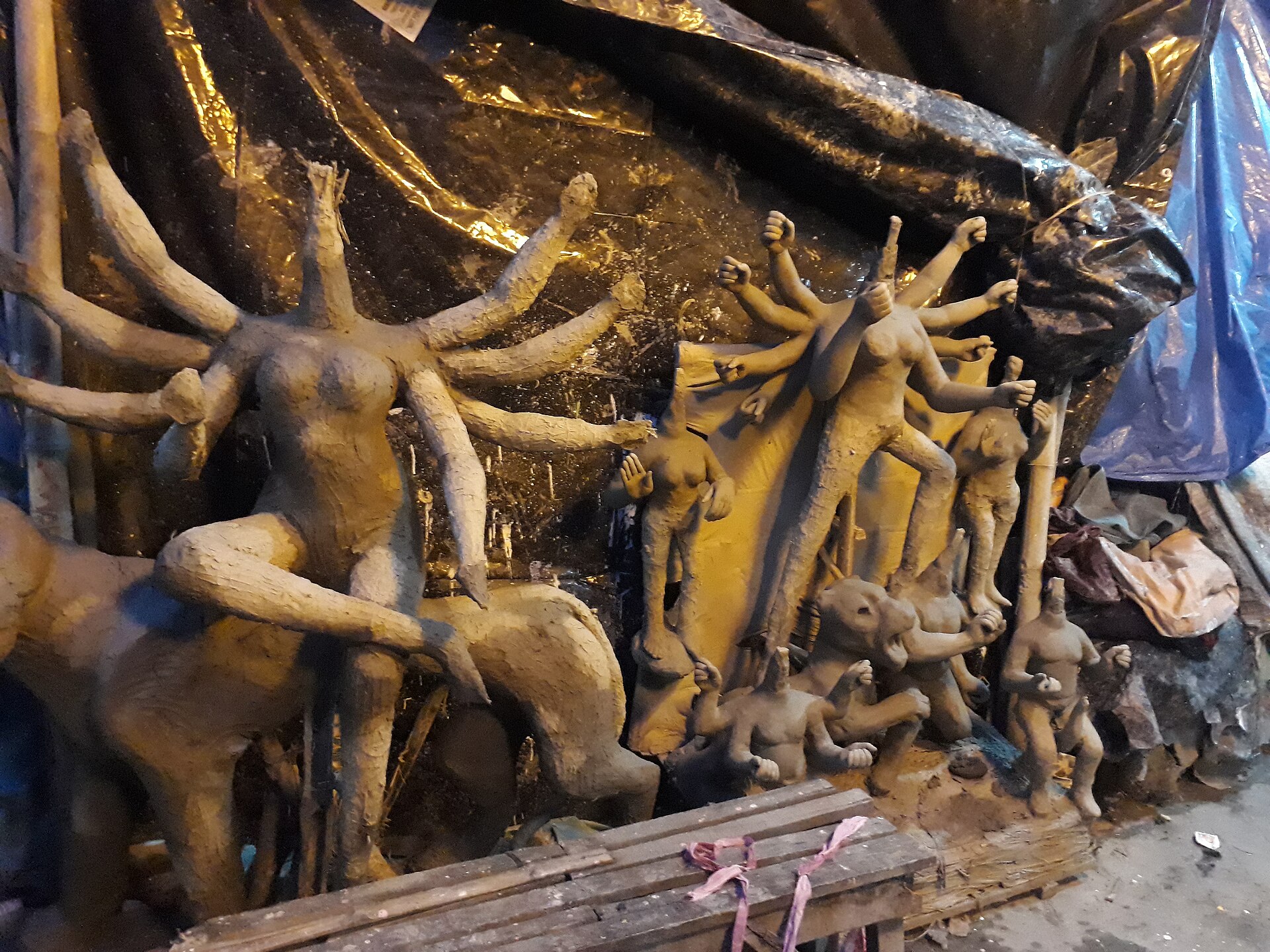 Artisan painting a clay Durga idol in the Kumartuli potters quarter of Kolkata