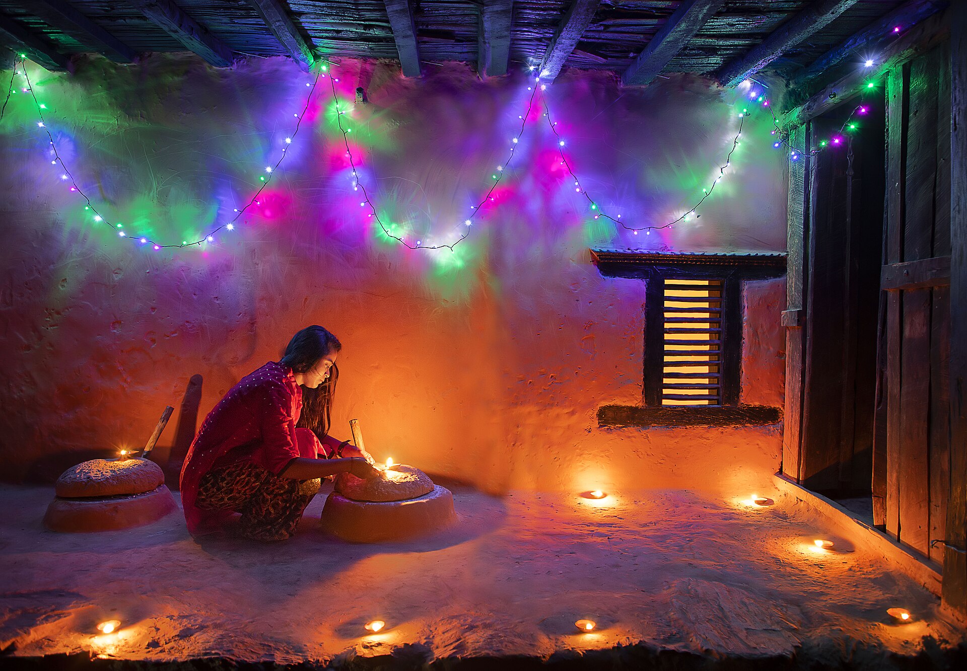 Oil lamps being lit during Tihar festival in Nepal