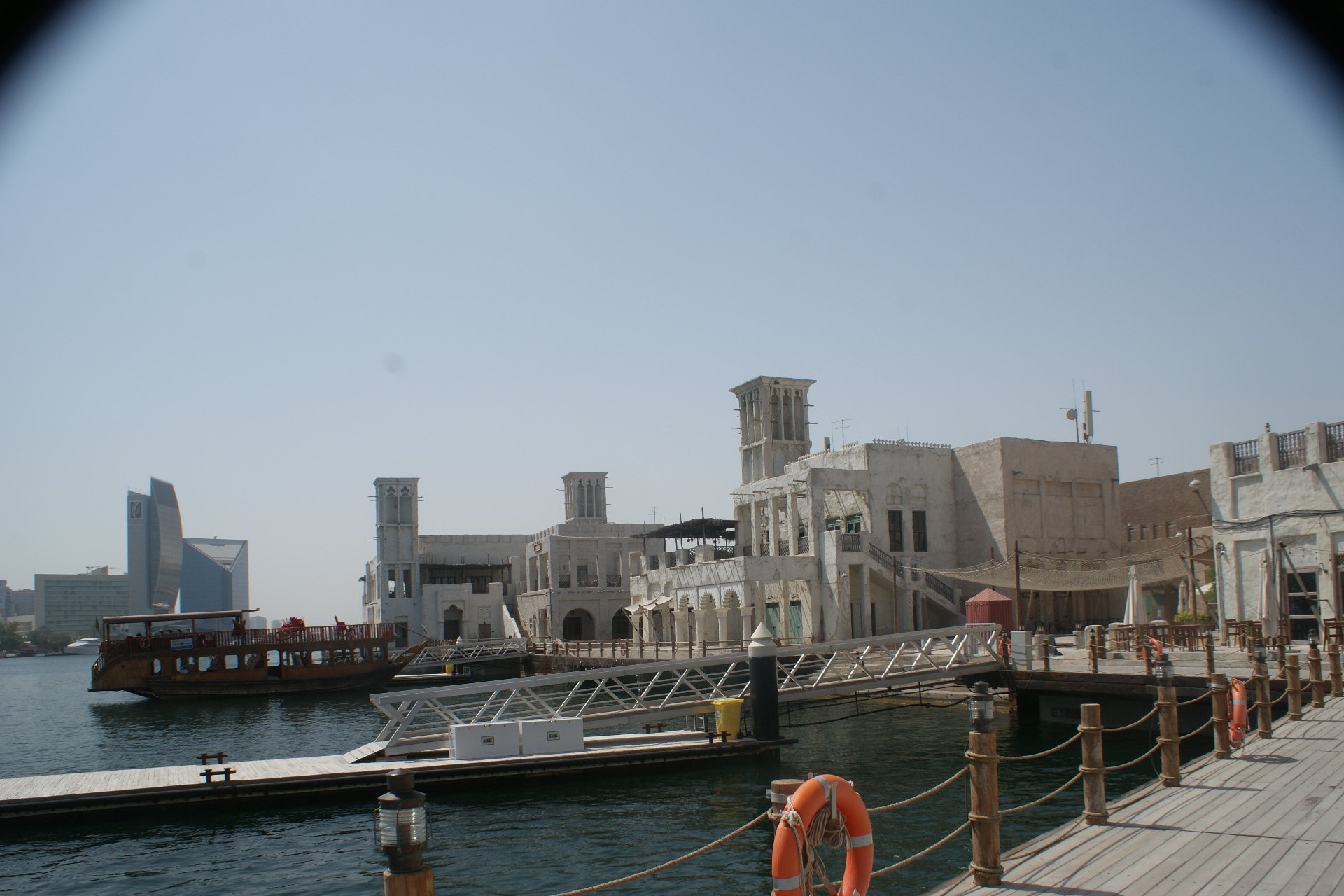 Al Seef on Dubai Creek with wind tower houses and an abra, venue of the Diwali fireworks