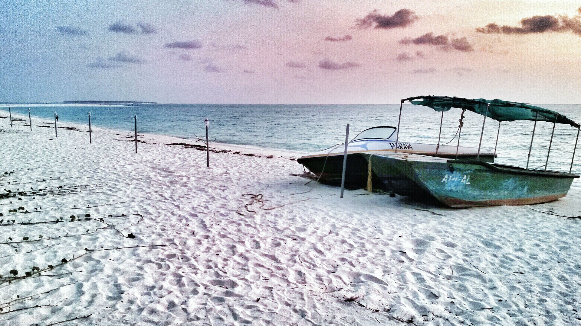 Glass-bottom boats pulled up on the white sand beach at Kadmat Island, Lakshadweep