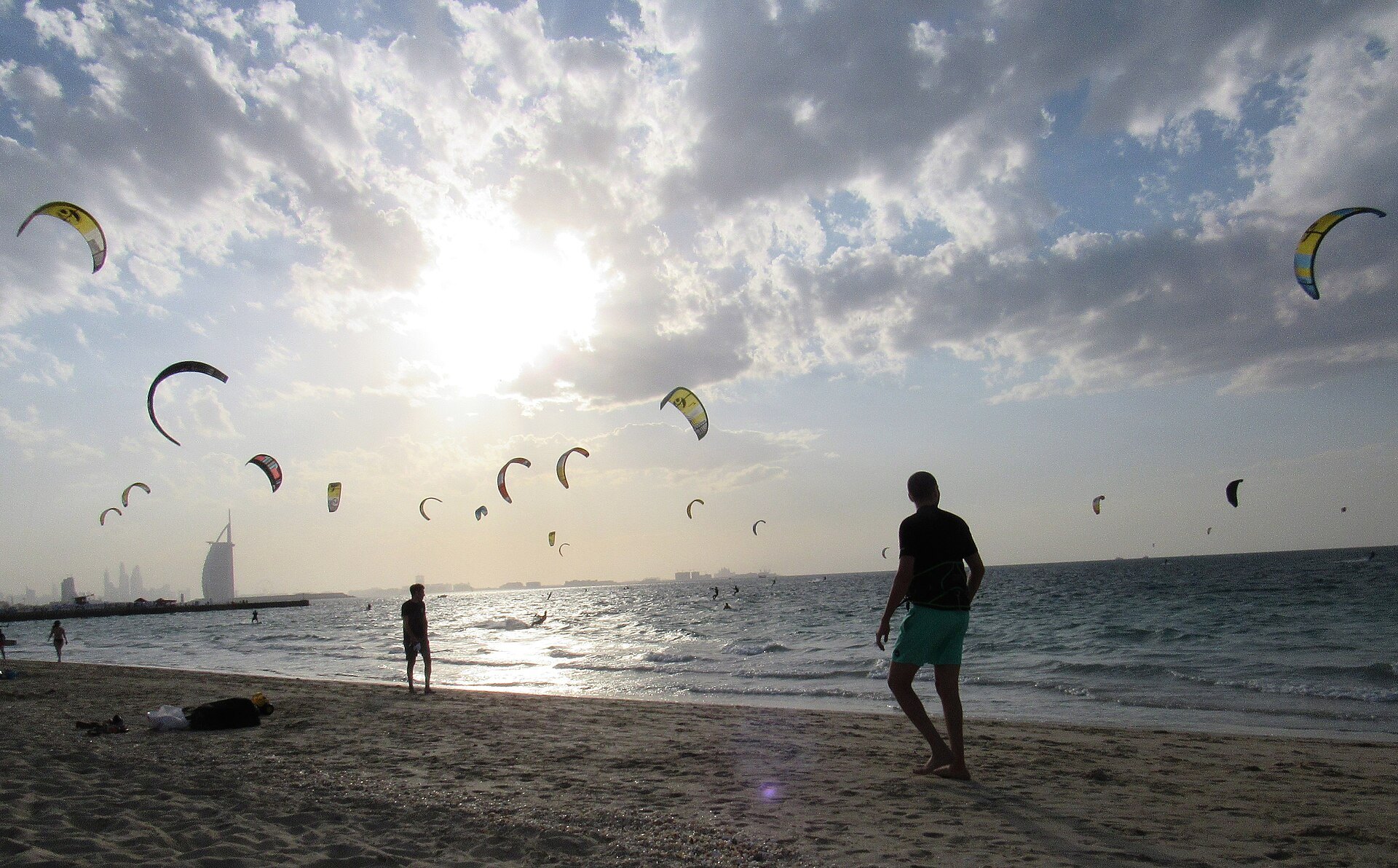 Kite surfers at Kite Beach Dubai with the Burj Al Arab in the distance