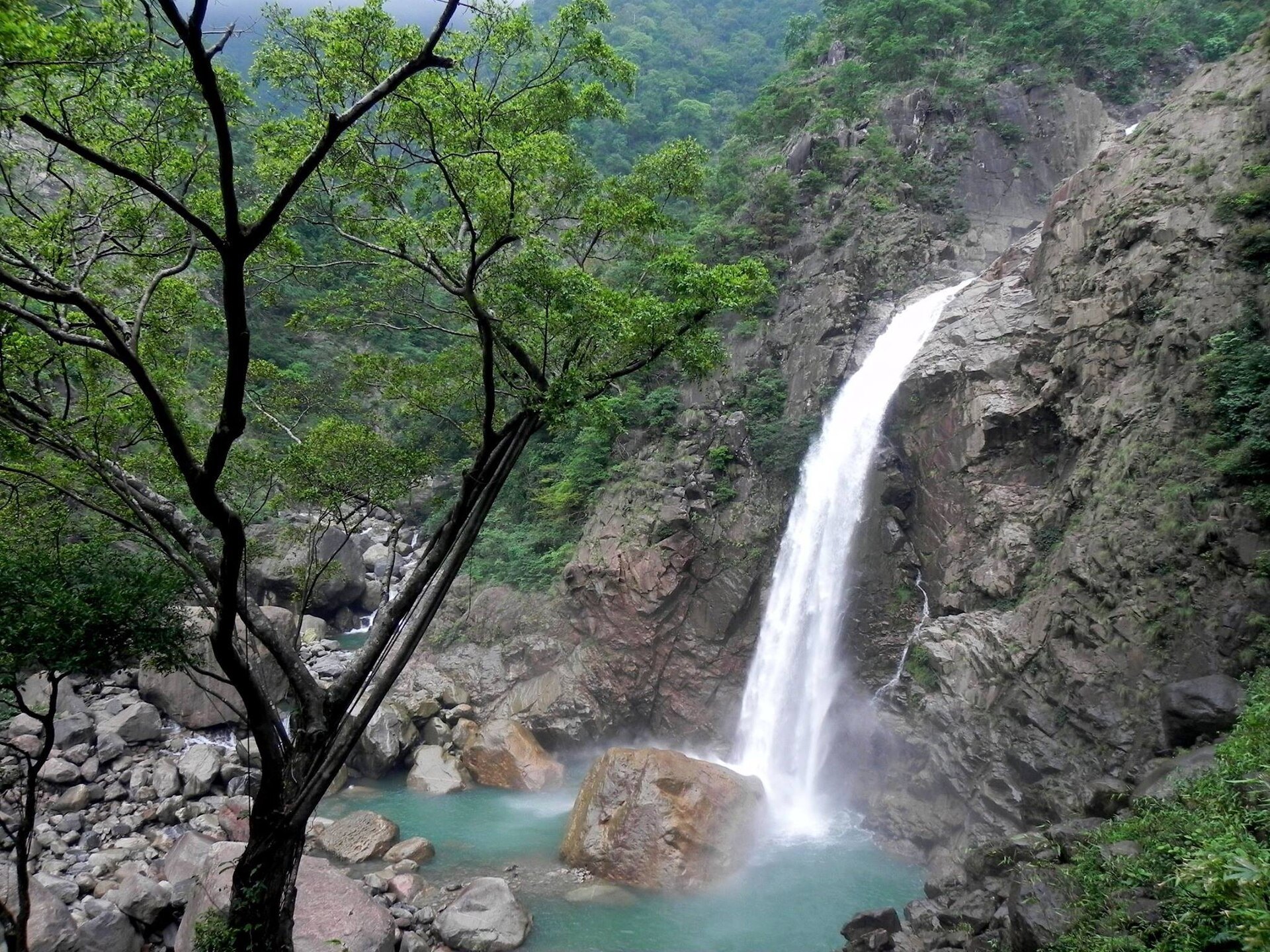 Rainbow Falls and its blue pool beyond Nongriat in Meghalaya