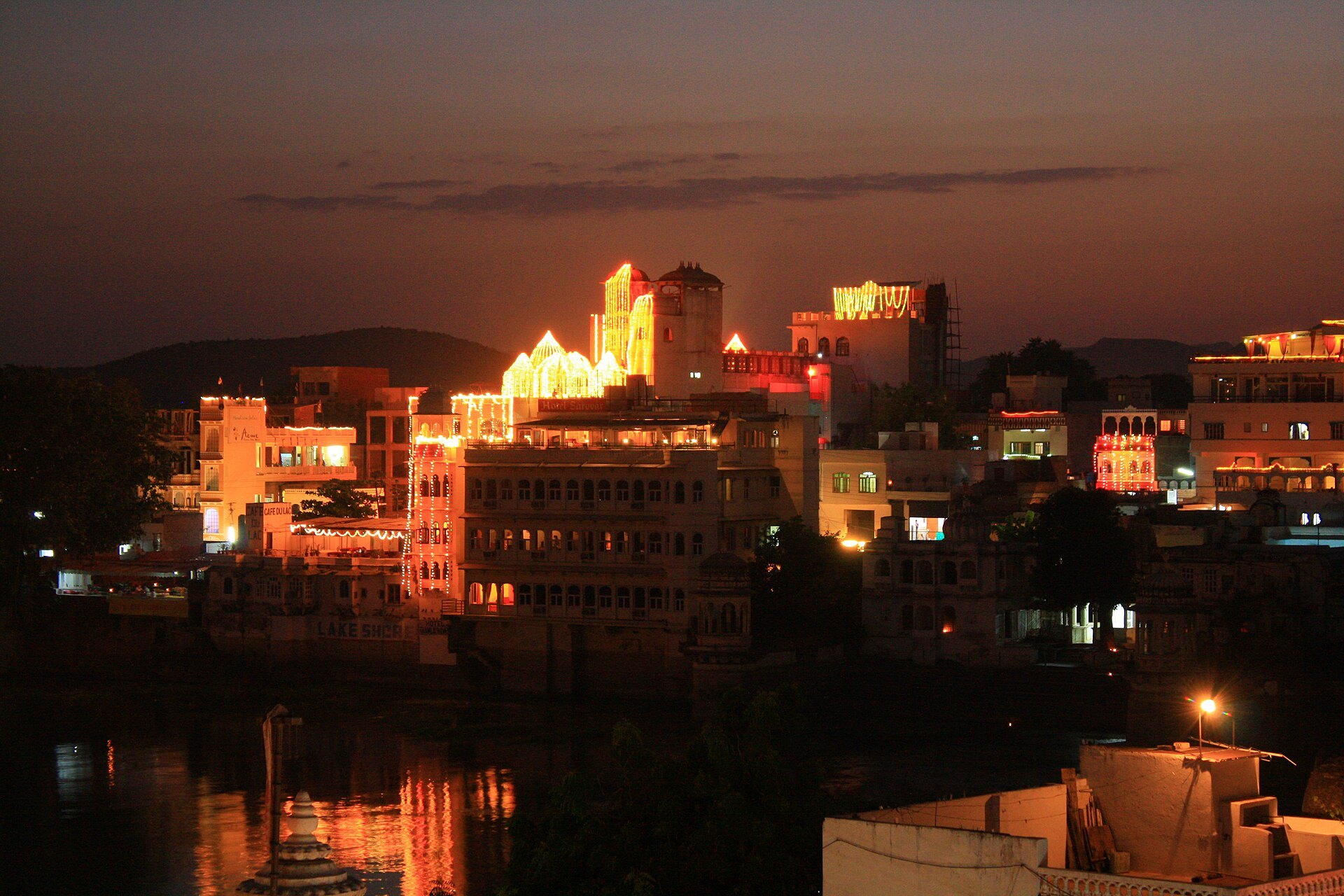 Havelis lit for Diwali beside Lake Pichola in Udaipur at dusk